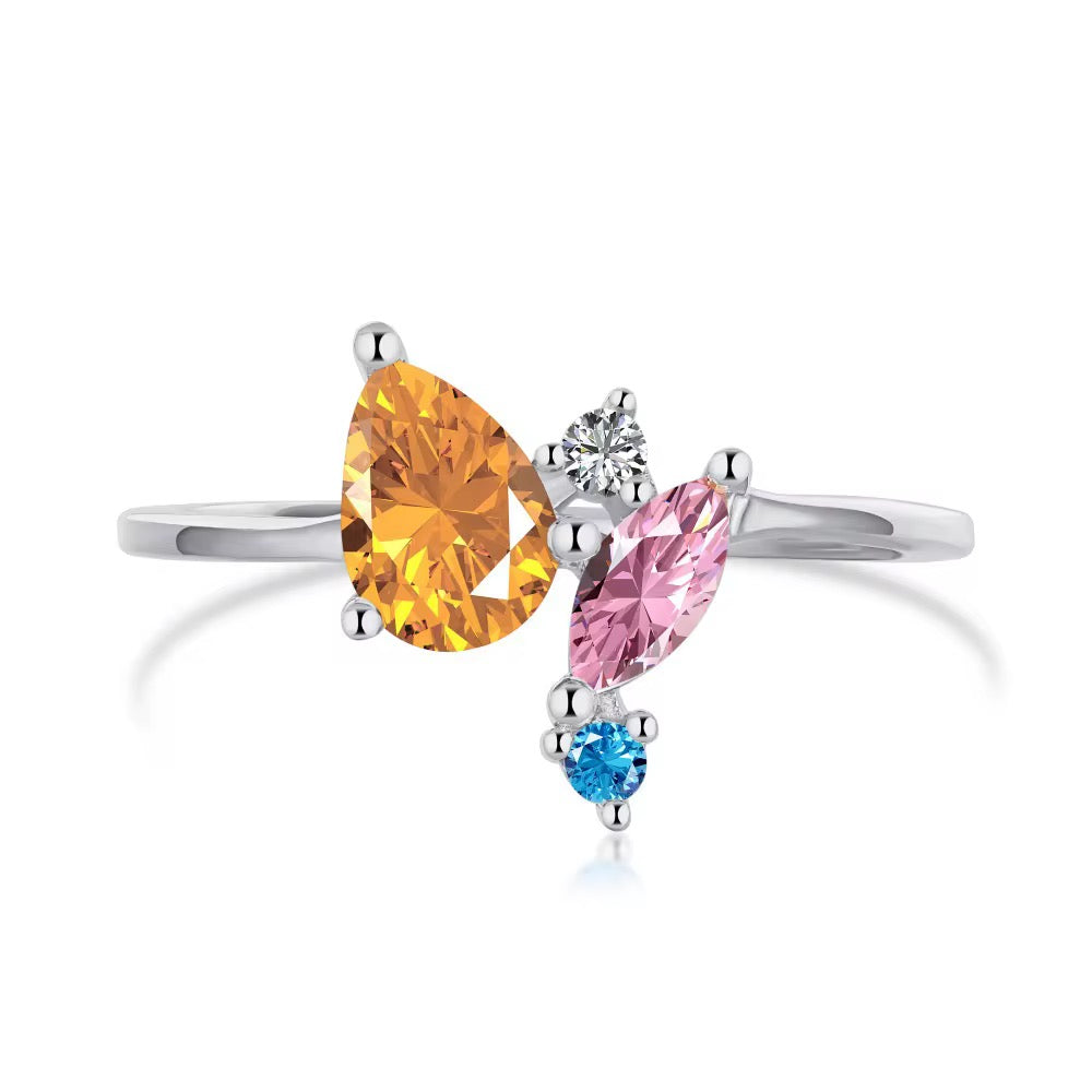 Thin silver-tone ring with a cluster of orange pear, pink marquise, clear and blue stones