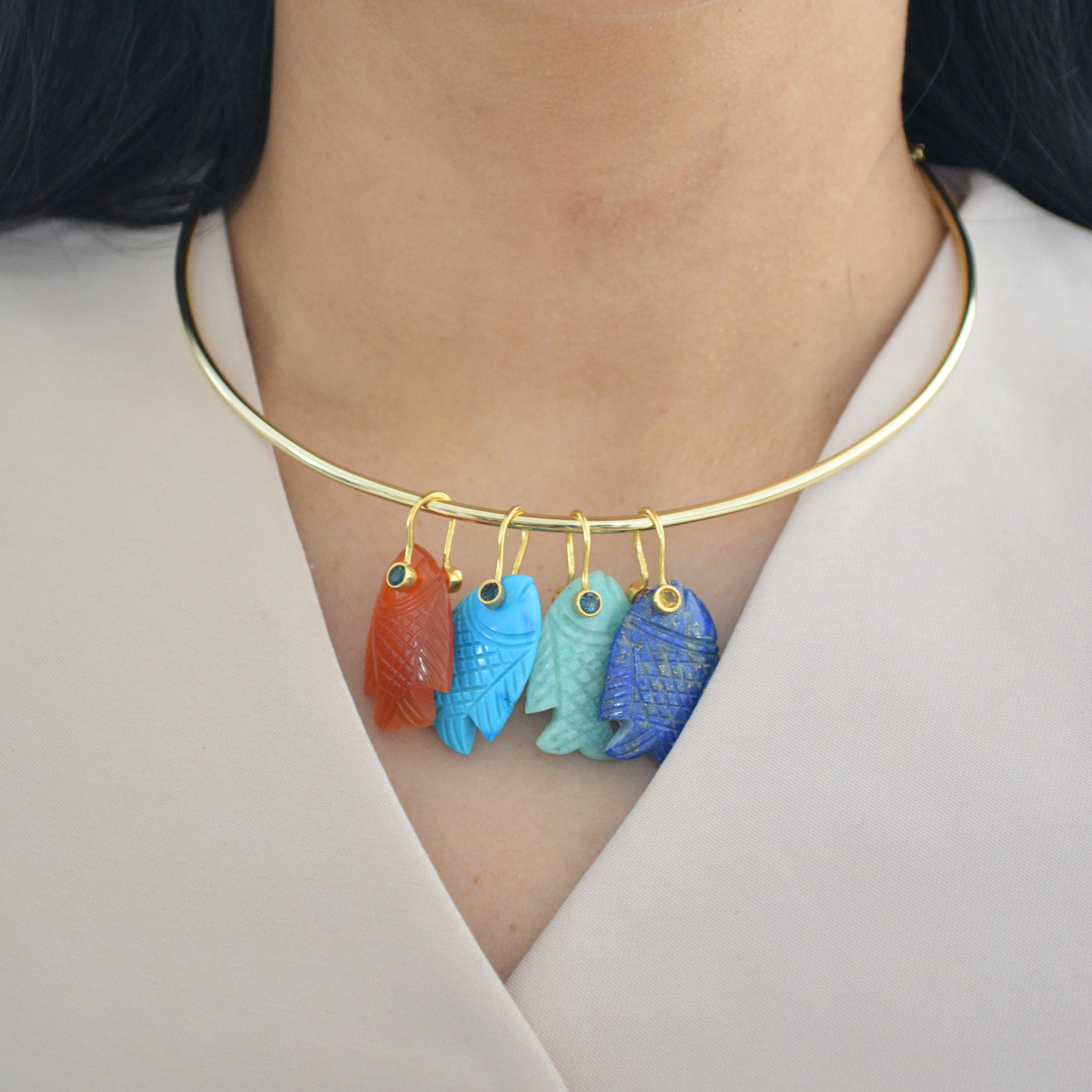 Woman wearing Fish Pendant Necklace with gold jewelry