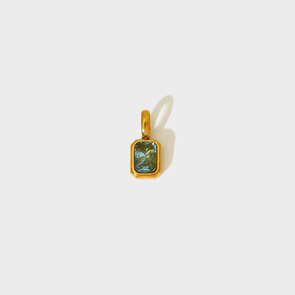 Aqua blue birthstone charm in a gold-plated rectangular bezel — MARO Jewelry.