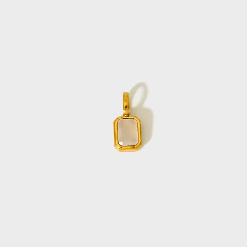 Soft beige/clear birthstone charm in a gold-plated rectangular bezel — MARO Jewelry.