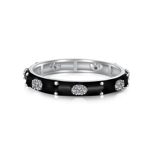 Black enamel ring with small studs and oval clusters of sparkling stones around a silver-tone band