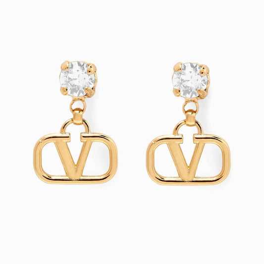 Pair of drop earrings with a clear prong-set stone above an open V-shaped gold-tone frame