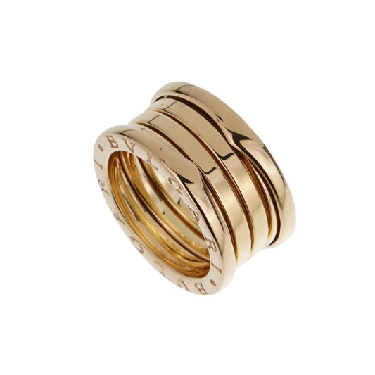 Coiled multi-band polished gold-tone ring with engraved lettering along the outer edges