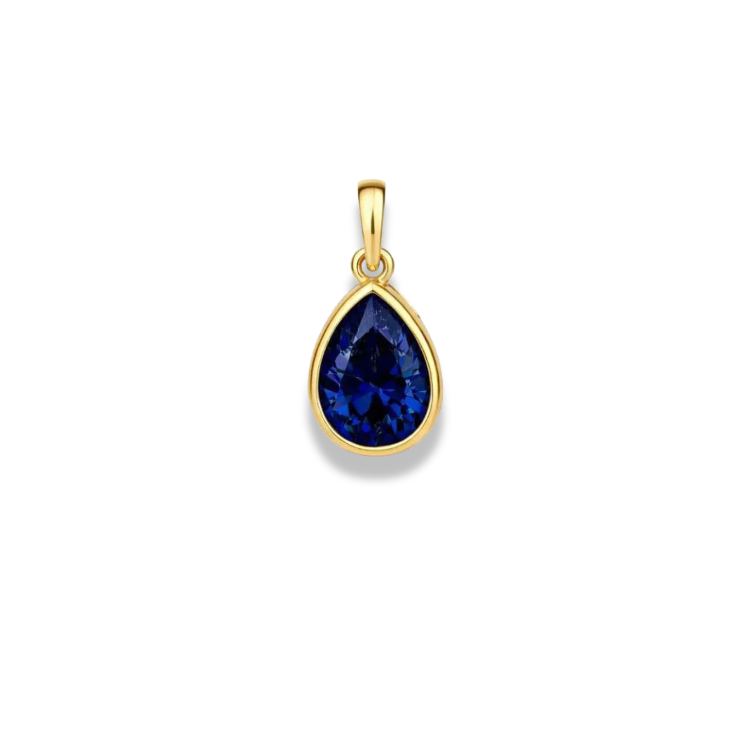 Dije de piedra azul profundo en forma de gota con engaste en tono dorado y una pequeña argolla, sobre fondo blanco