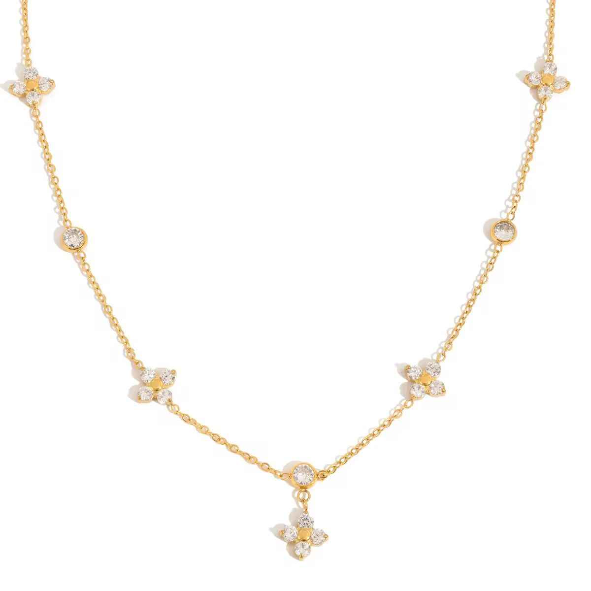 Delicate gold-tone chain necklace with small flower motifs set with clear stones and one flower drop at the center