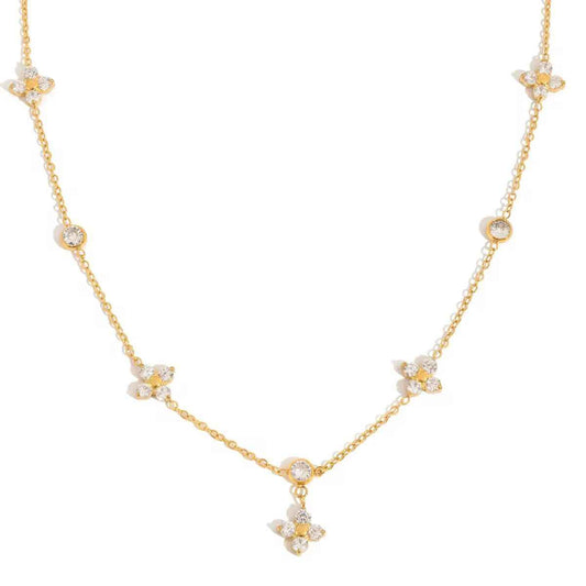Delicate gold-tone chain necklace with small flower motifs set with clear stones and one flower drop at the center