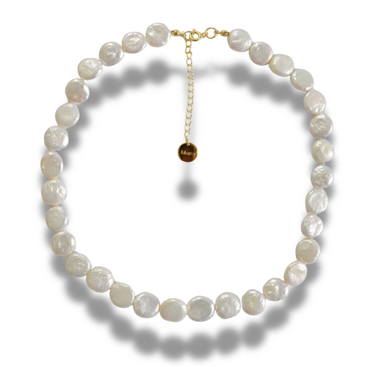 Necklace of flat pearls in an even circle with a fine gold-tone adjustable chain and a small round tag, on white