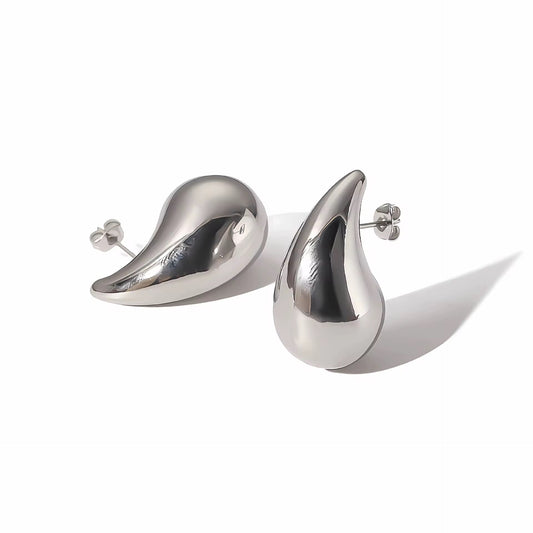 Pair of glossy silver-tone teardrop-shaped stud earrings with a mirror-like finish, on white