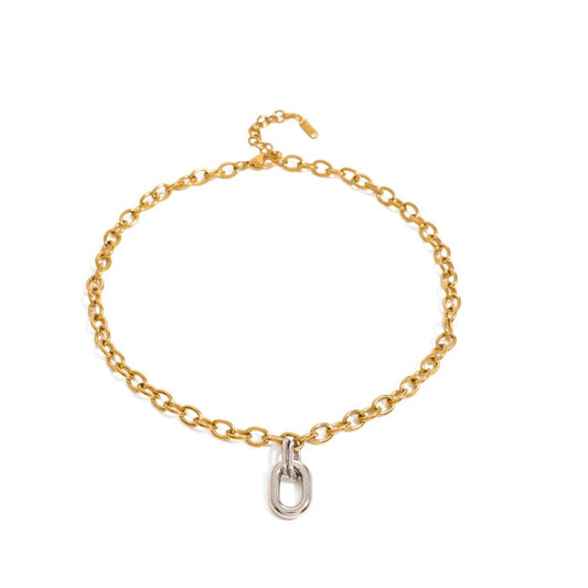 Gold-tone cable chain necklace with a polished silver-tone oval link at the center, on white