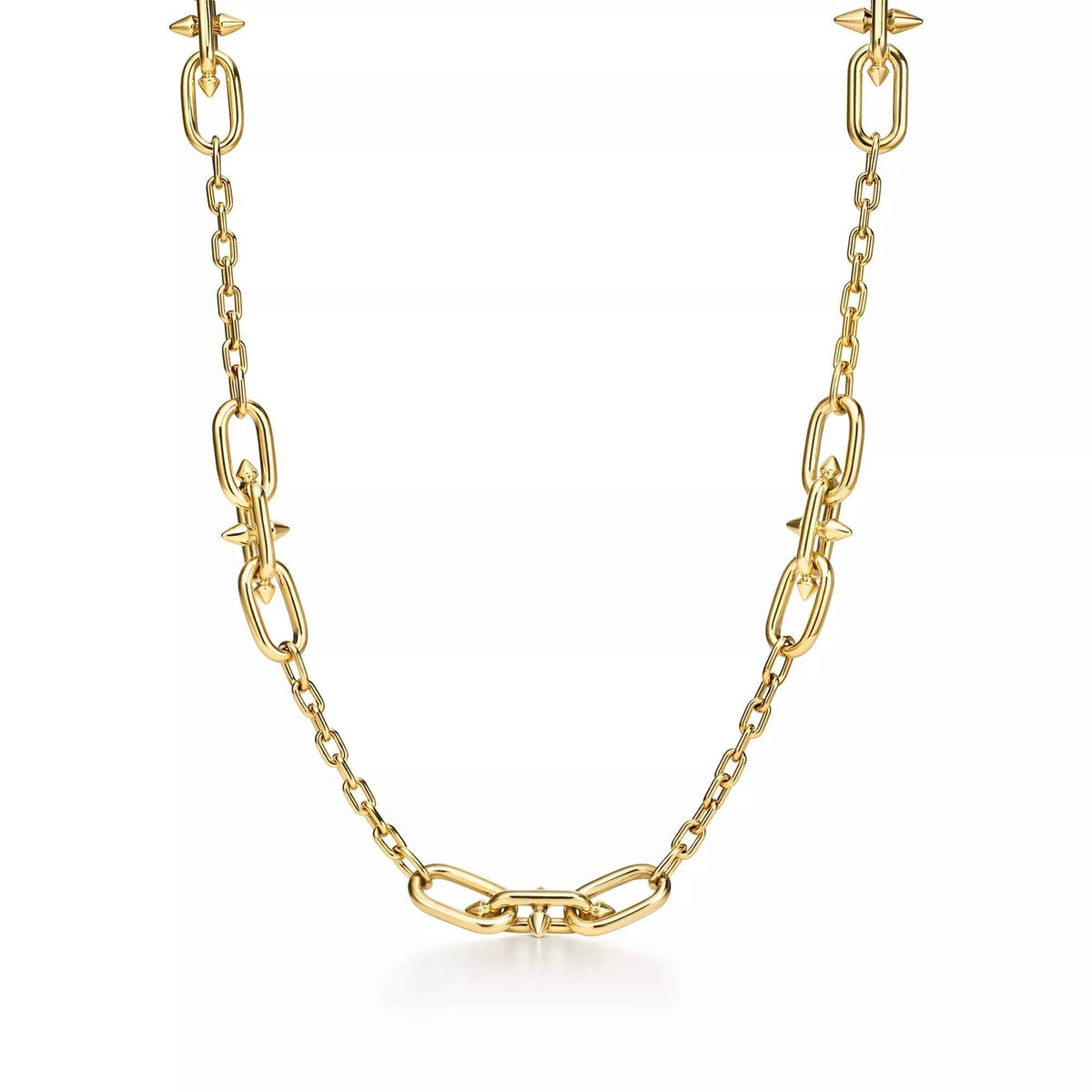 Gold-tone chain necklace of elongated links with small pointed connectors and a chunky center link, on white