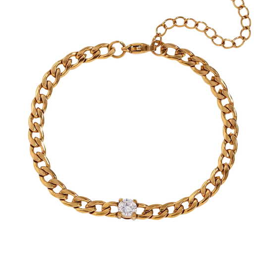 Gold-tone Cuban chain bracelet with a single clear zircon stone at the front and an extender chain