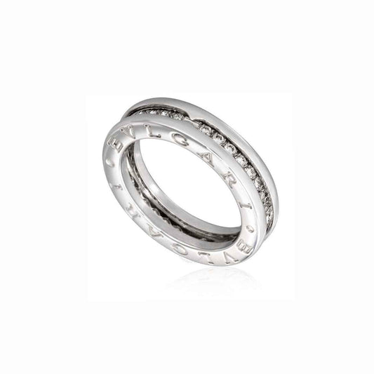 Layered silver-tone ring with engraved lettering on the outer bands and a row of small stones in the center