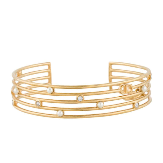 Open gold-tone cuff made of five slim bands with small white beads and clear stones