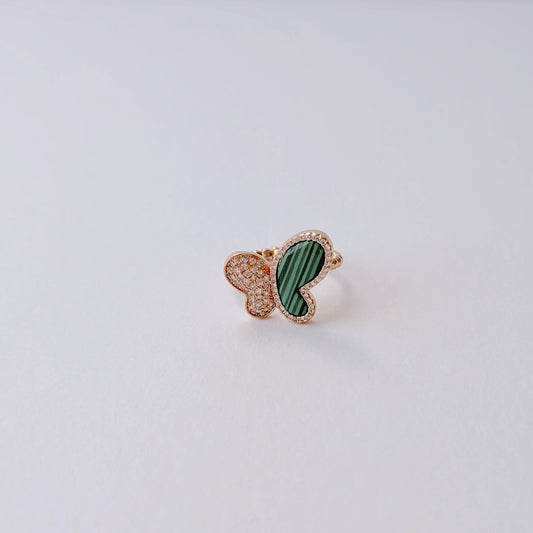 Open rose gold-color ring with a butterfly with one green wing