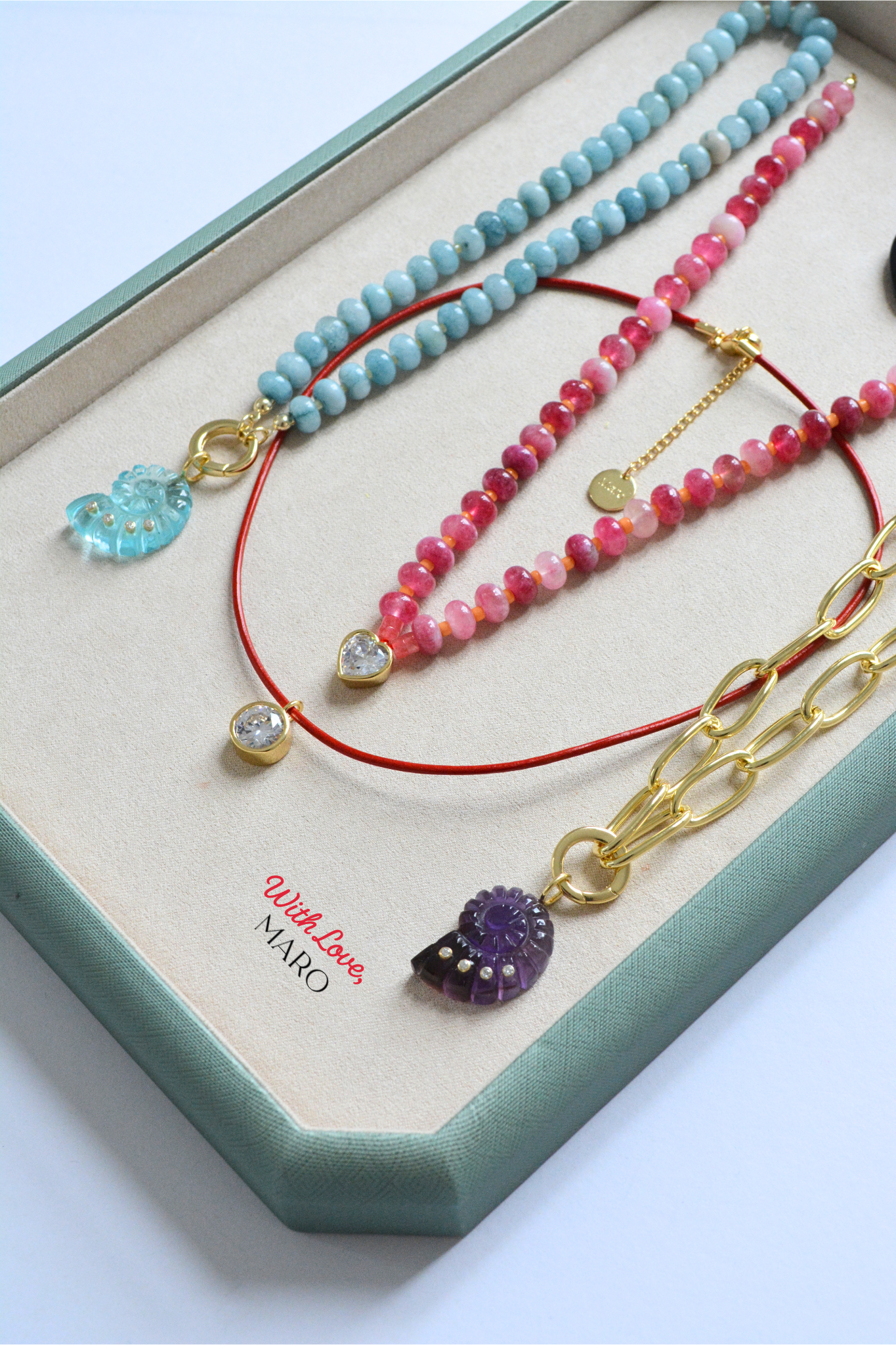 Pink and rose-toned beaded necklace by MARO featuring a delicate heart charm.