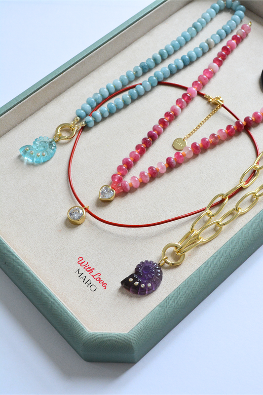 Pink and rose-toned beaded necklace by MARO featuring a delicate heart charm.