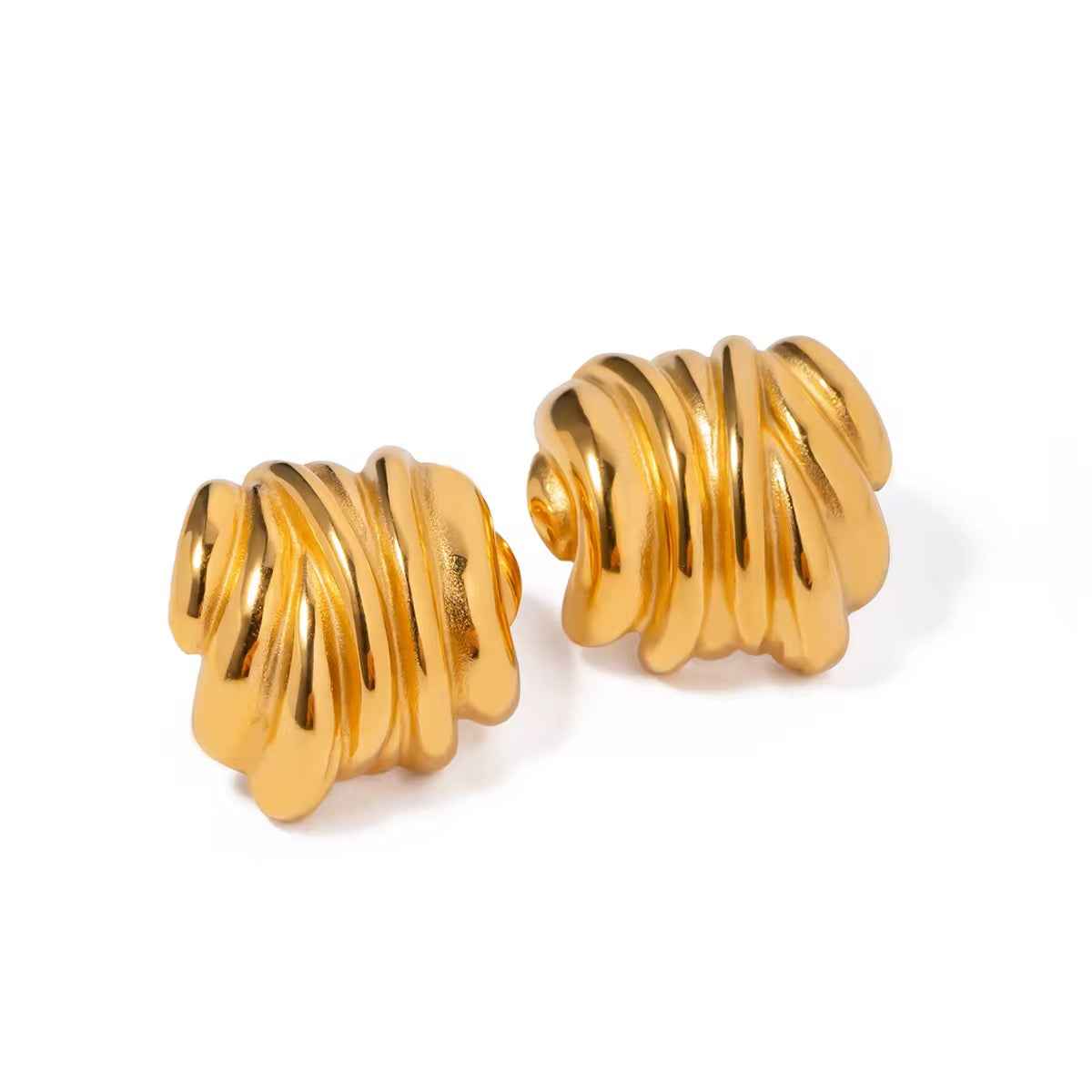 Pair of sculptural gold-colored earrings with a shiny ridged surface curving like folded ribbon