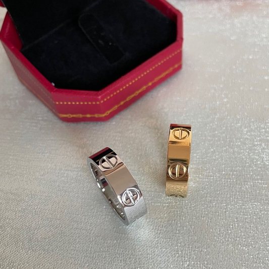 Silver-tone and gold-tone bands with a screw-style detail, resting in a dark red box