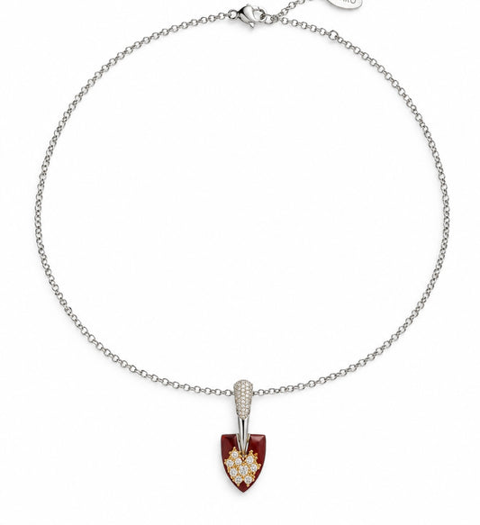 Delicate silver-tone chain necklace with a deep red shield pendant topped with a stone-set bar