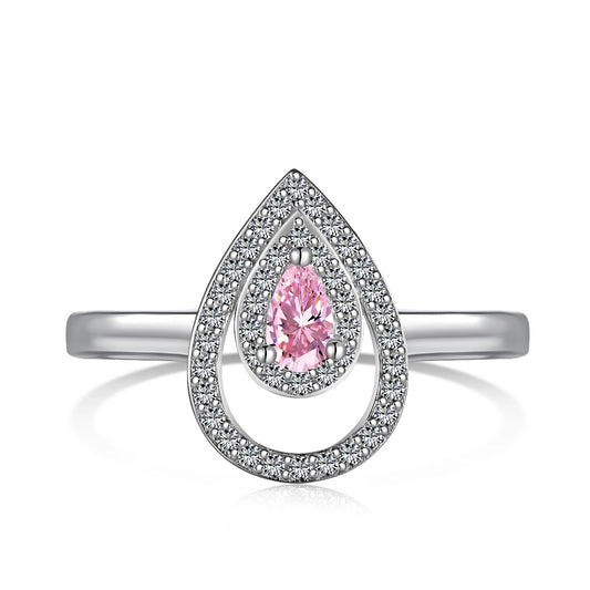 Silver-tone ring with a pear-shaped pink stone inside a teardrop frame of small clear stones, on white