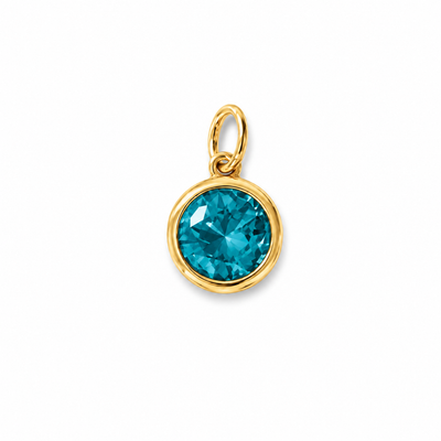 Dije redondo de piedra azul facetada en un engaste en tono dorado con una argolla en la parte superior