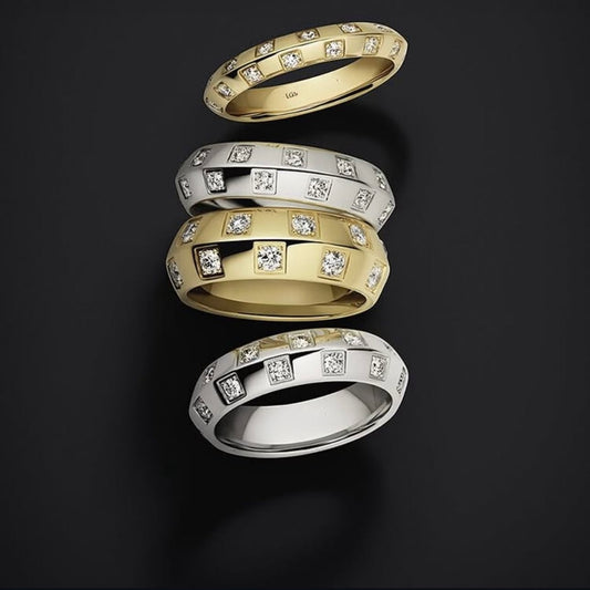 Stacked gold-tone and silver-tone bands with scattered small sparkling stones on a black background