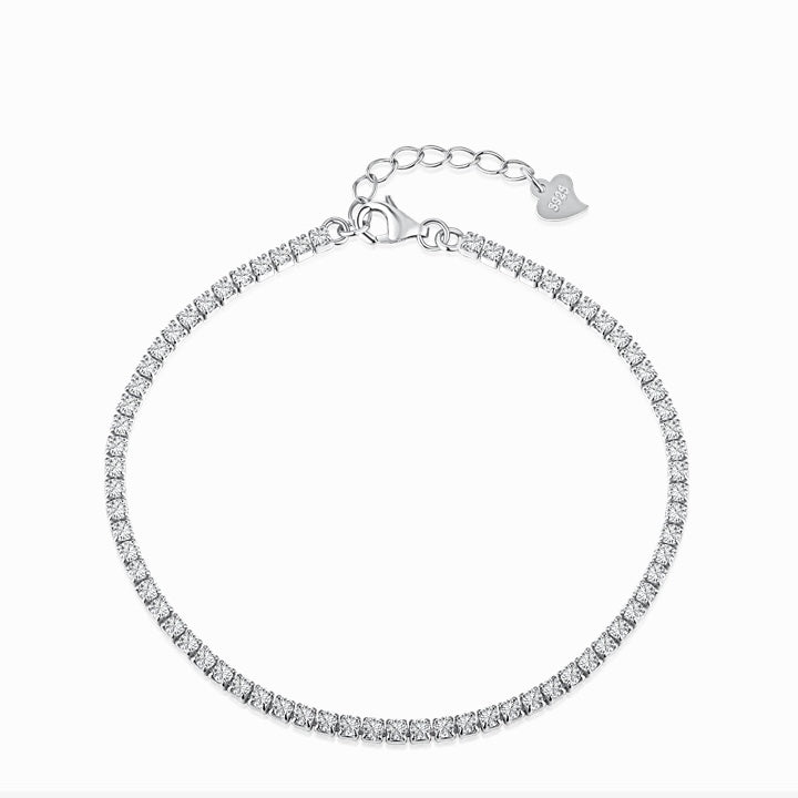 Tennis bracelet with a single row of small clear stones and an extension chain with a heart tag