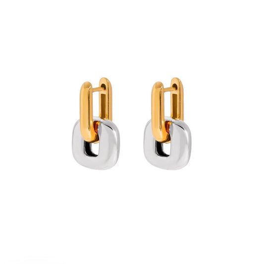 Pair of two-tone earrings with gold-tone huggie tops and chunky silver-tone square drops, on white